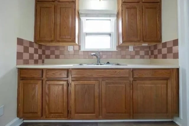 147 Draper Ave, Waterford, MI 48328 - kitchen with brown cabinetry, light countertops, and decorative backsplash