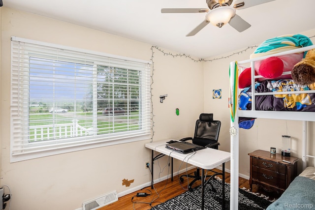 11508 Grand Blanc Rd, Gaines, MI 48436 - bedroom with wood finished floors, an office area, and a ceiling fan