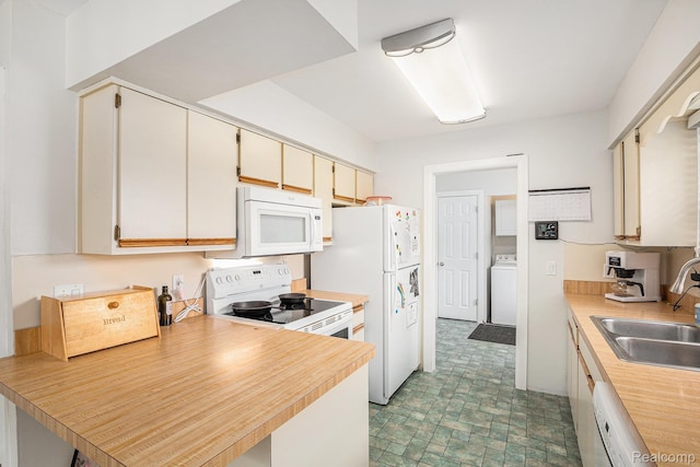 11508 Grand Blanc Rd, Gaines, MI 48436 - kitchen featuring white appliances, washer / clothes dryer, light countertops, and a peninsula