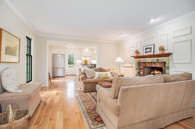 5145 Hensley Dr, Ann Arbor, MI 48103 - living area featuring light wood-style flooring, crown molding, and a fireplace