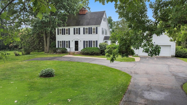 5145 Hensley Dr, Ann Arbor, MI 48103 - colonial inspired home with asphalt driveway, a chimney, a front lawn, a garage, and a shingled roof