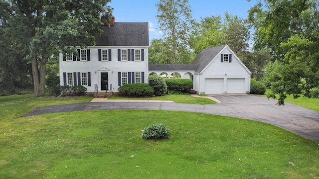 5145 Hensley Dr, Ann Arbor, MI 48103 - colonial-style house featuring asphalt driveway, a front lawn, and a chimney