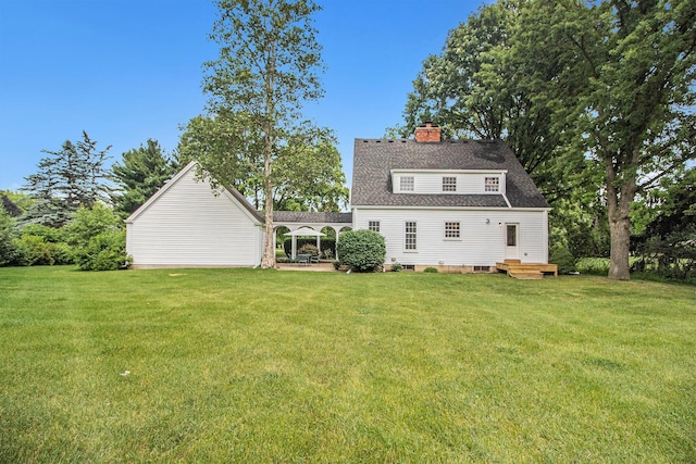 5145 Hensley Dr, Ann Arbor, MI 48103 - rear view of property featuring a chimney, a yard, and roof with shingles