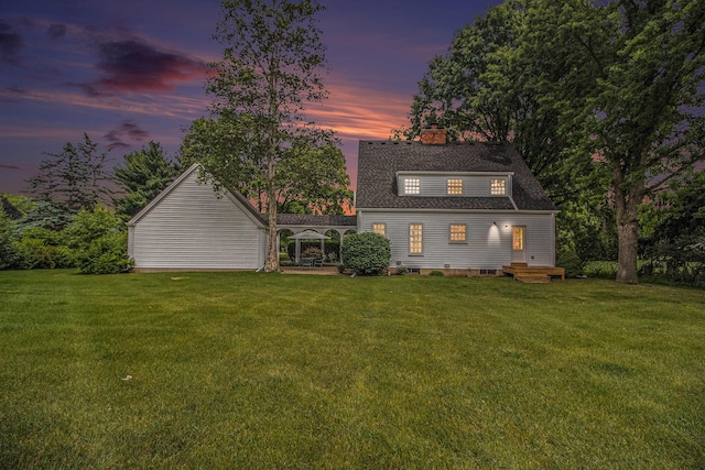 5145 Hensley Dr, Ann Arbor, MI 48103 - back of property with a chimney, a lawn, and a shingled roof