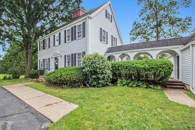 5145 Hensley Dr, Ann Arbor, MI 48103 - view of front of home featuring a chimney and a front yard