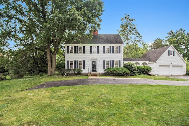 5145 Hensley Dr, Ann Arbor, MI 48103 - colonial home featuring driveway, a chimney, and a front lawn