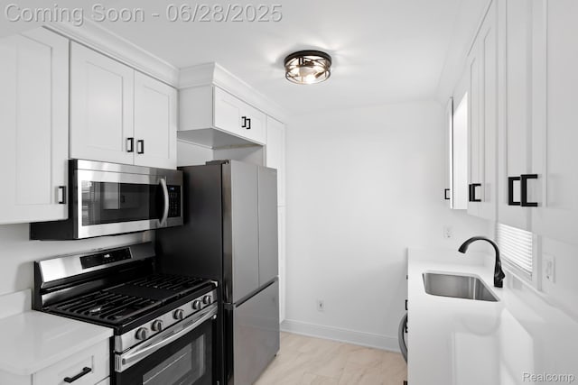 1590 Chapin Ave, Birmingham, MI 48009 - kitchen featuring appliances with stainless steel finishes, white cabinetry, light countertops, and light marble finish floors