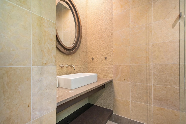 7085 Youngren Rd, Three Oaks, MI 49128 - bathroom with vanity, tile walls, and backsplash