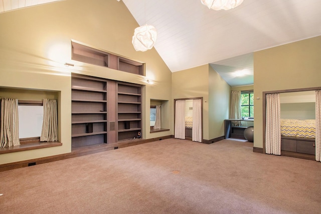 7085 Youngren Rd, Three Oaks, MI 49128 - unfurnished living room with carpet flooring, high vaulted ceiling, and built in shelves