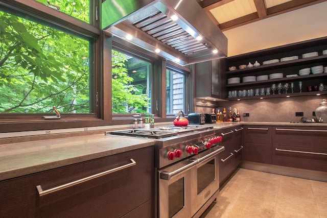 7085 Youngren Rd, Three Oaks, MI 49128 - kitchen featuring range with two ovens, wall chimney exhaust hood, dark brown cabinets, backsplash, and open shelves