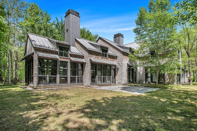 7085 Youngren Rd, Three Oaks, MI 49128 - back of property featuring a standing seam roof, a chimney, and a metal roof
