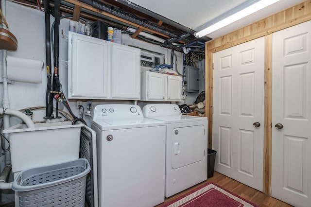 7702 N Gleneagle Dr, Kalamazoo, MI 49048 - laundry room with cabinet space, separate washer and dryer, electric panel, and light wood finished floors