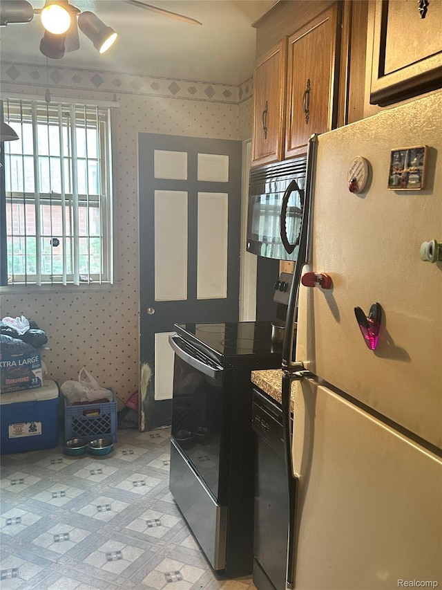 16236 Stansbury St, Detroit, MI 48235 - kitchen with black appliances, brown cabinets, ceiling fan, and wallpapered walls