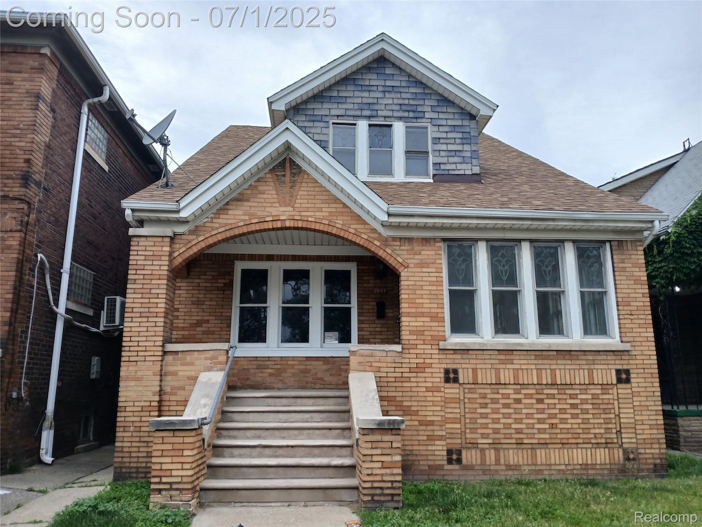 2611 Holbrook St, Hamtramck, MI 48212 - view of front facade featuring brick siding, a shingled roof, and a porch
