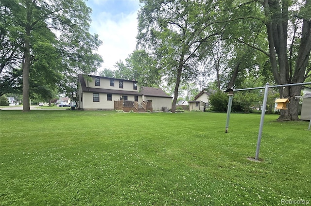 11019 Washington Ave, Mount Morris, MI 48458 - view of grassy yard with a shed and a wooden deck