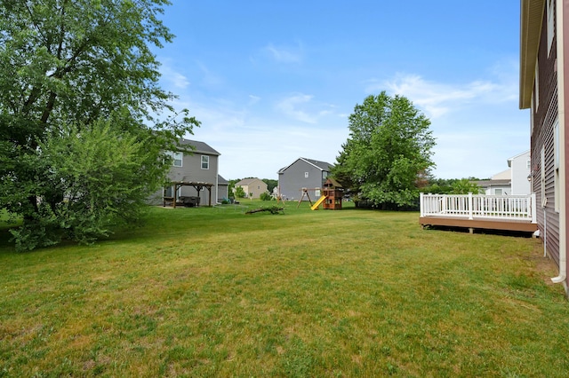 5661 Attleberry Ave, Kalamazoo, MI 49009 - view of green lawn with a playground and a wooden deck