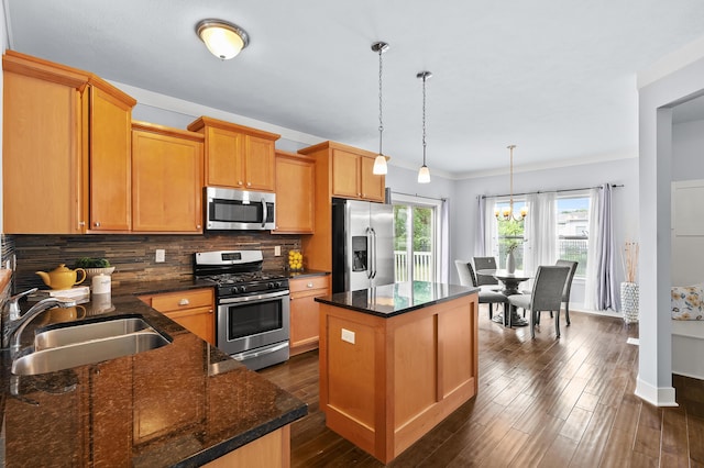 5661 Attleberry Ave, Kalamazoo, MI 49009 - kitchen with stainless steel appliances, a center island, backsplash, dark wood-style flooring, and dark stone counters