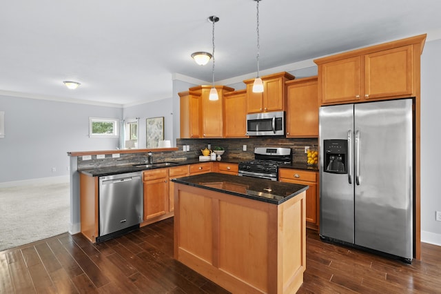 5661 Attleberry Ave, Kalamazoo, MI 49009 - kitchen with stainless steel appliances, a peninsula, dark wood-style floors, decorative backsplash, and ornamental molding