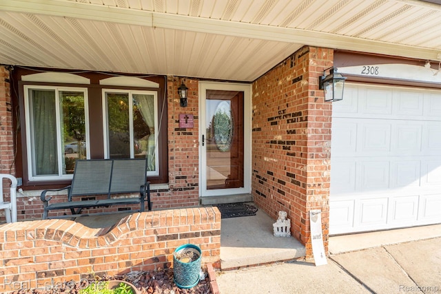 2308 Kipling Dr, Sterling Heights, MI 48310 - doorway to property featuring covered porch, brick siding, and an attached garage
