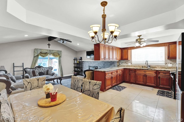 2308 Kipling Dr, Sterling Heights, MI 48310 - dining room featuring a ceiling fan, vaulted ceiling, a chandelier, light tile patterned floors, and healthy amount of natural light