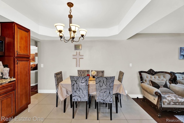 2308 Kipling Dr, Sterling Heights, MI 48310 - dining space with a tray ceiling, a chandelier, and light tile patterned floors