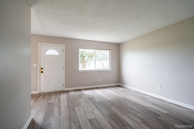 20327 Ellis St, Roseville, MI 48066 - entryway featuring wood finished floors and a textured ceiling