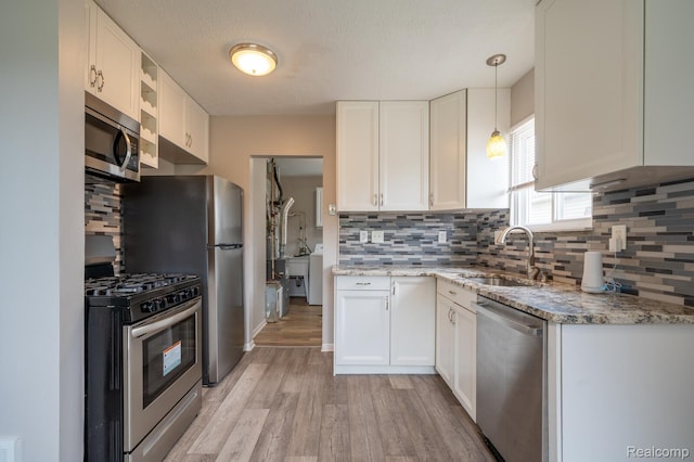 20327 Ellis St, Roseville, MI 48066 - kitchen featuring appliances with stainless steel finishes, light wood-style floors, and white cabinets