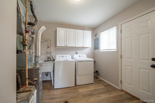 20327 Ellis St, Roseville, MI 48066 - washroom featuring washer and dryer, cabinet space, electric panel, and light wood-style flooring