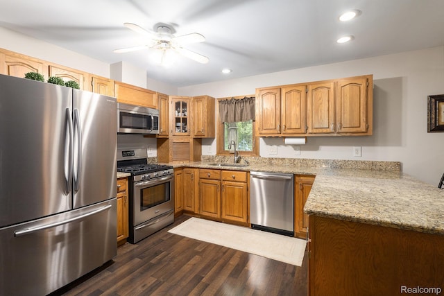 3349 Shimmons Rd, Auburn Hills, MI 48326 - kitchen featuring stainless steel appliances, a ceiling fan, dark wood-type flooring, brown cabinets, and light stone countertops