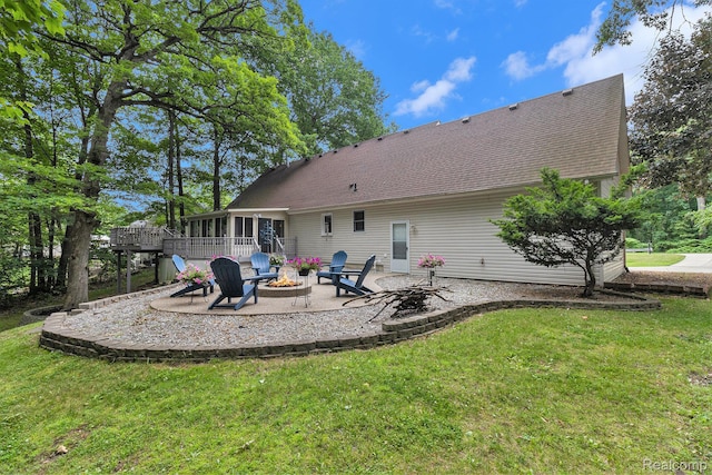 3349 Shimmons Rd, Auburn Hills, MI 48326 - rear view of house featuring a fire pit, a sunroom, a patio area, a yard, and roof with shingles