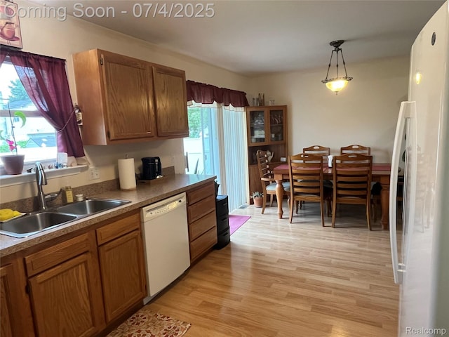 19754 E 14 Mile Rd, Roseville, MI 48066 - kitchen with white appliances, brown cabinets, light wood-type flooring, and decorative light fixtures