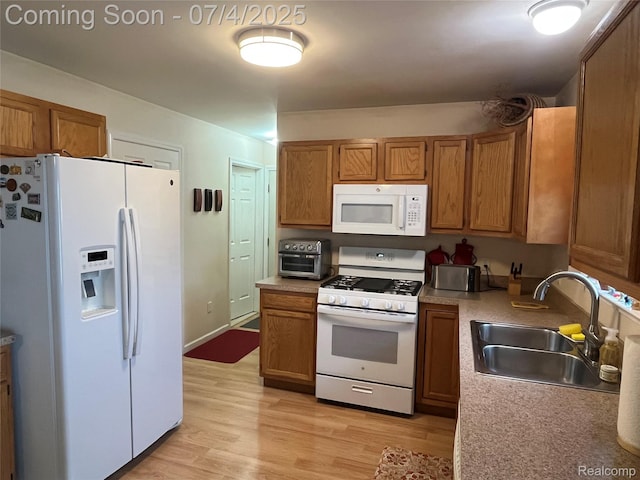 19754 E 14 Mile Rd, Roseville, MI 48066 - kitchen with white appliances, brown cabinetry, light wood finished floors, and light countertops