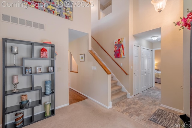 897 Whisperwood Trl, Fenton, MI 48430 - staircase with a high ceiling and carpet floors