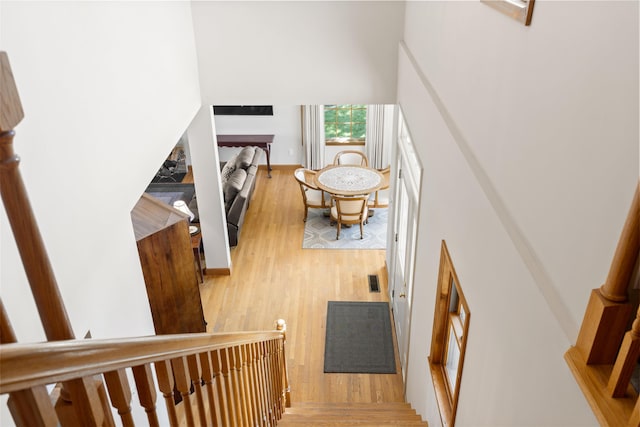 11713 Linderman Rd, Bear Lake, MI 49614 - staircase featuring wood finished floors and a high ceiling