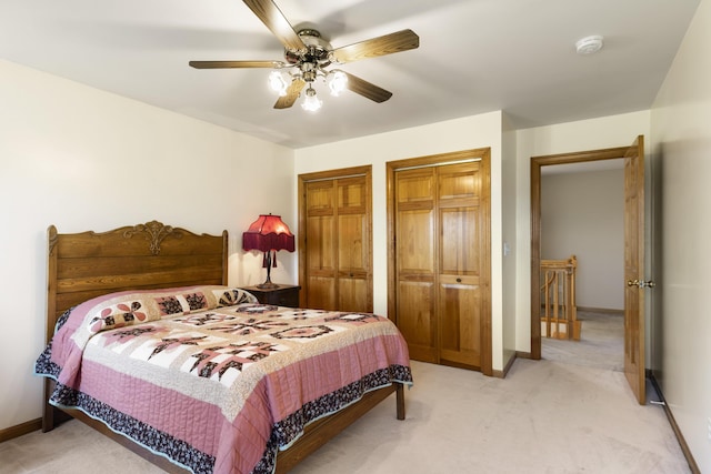 11713 Linderman Rd, Bear Lake, MI 49614 - bedroom with two closets, light carpet, and a ceiling fan