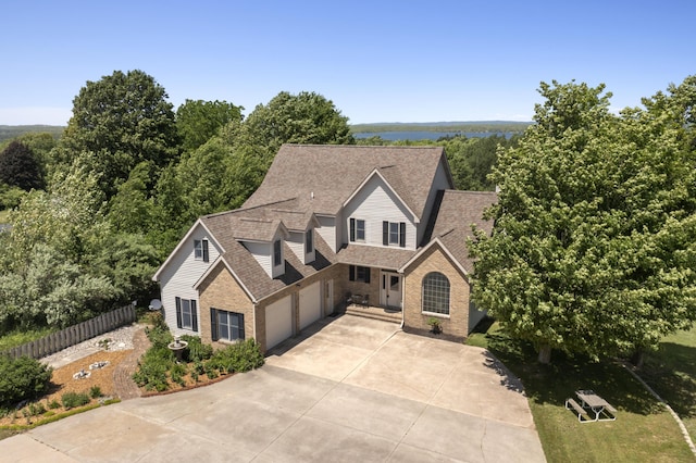 11713 Linderman Rd, Bear Lake, MI 49614 - traditional home featuring brick siding, driveway, an attached garage, and roof with shingles