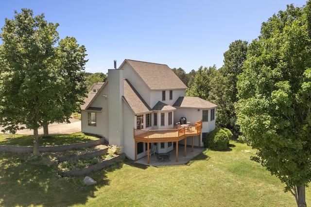 11713 Linderman Rd, Bear Lake, MI 49614 - back of property with a deck, a patio area, a yard, a shingled roof, and a chimney