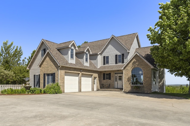11713 Linderman Rd, Bear Lake, MI 49614 - traditional-style house featuring brick siding, a shingled roof, concrete driveway, and a garage