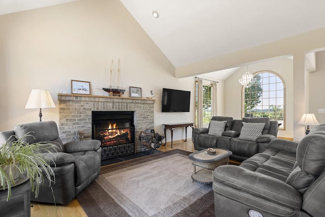 11713 Linderman Rd, Bear Lake, MI 49614 - living room with a brick fireplace, wood finished floors, a chandelier, and high vaulted ceiling