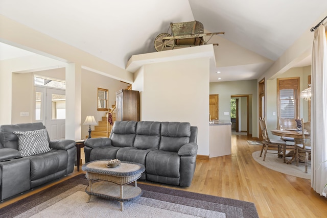 11713 Linderman Rd, Bear Lake, MI 49614 - living room featuring stairway, healthy amount of natural light, high vaulted ceiling, light wood-type flooring, and recessed lighting