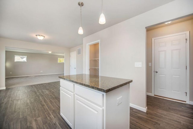 5680 Landrum Trl, Portage, MI 49024 - kitchen with a kitchen island, dark wood-style flooring, white cabinetry, and hanging light fixtures