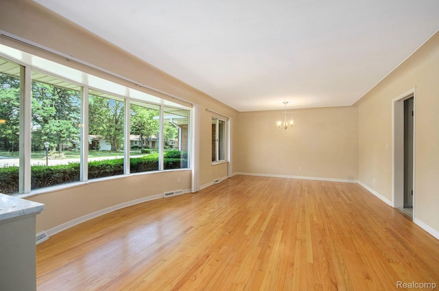 18319 Greenwald Dr, Southfield, MI 48075 - empty room with a chandelier and light wood-style floors
