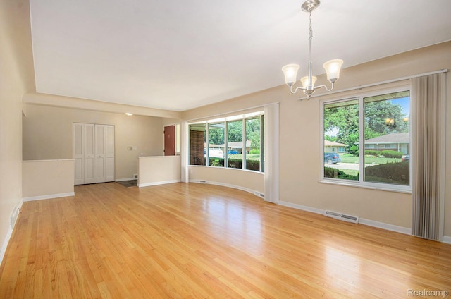 18319 Greenwald Dr, Southfield, MI 48075 - unfurnished room with a chandelier and light wood-style floors