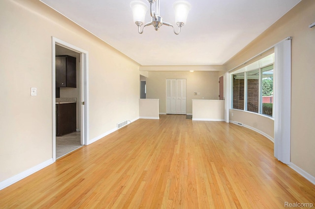 18319 Greenwald Dr, Southfield, MI 48075 - spare room featuring a chandelier and light wood finished floors