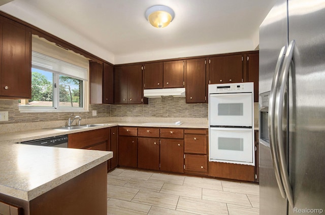 18319 Greenwald Dr, Southfield, MI 48075 - kitchen with stainless steel appliances, under cabinet range hood, backsplash, and light countertops