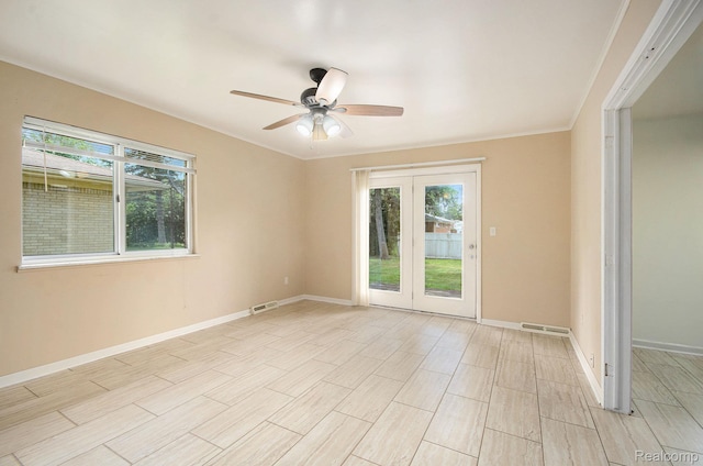 18319 Greenwald Dr, Southfield, MI 48075 - unfurnished room featuring french doors, healthy amount of natural light, a ceiling fan, light wood finished floors, and crown molding