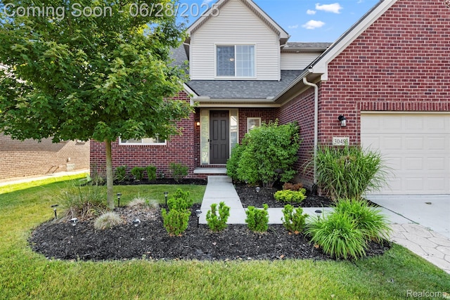 30493 Bradmore Rd, Warren, MI 48092 - traditional home featuring a garage, roof with shingles, brick siding, and a front yard