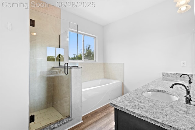 30493 Bradmore Rd, Warren, MI 48092 - bathroom featuring a bath, wood finished floors, vanity, and a shower stall