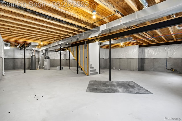 30493 Bradmore Rd, Warren, MI 48092 - unfinished below grade area featuring stairway, water heater, and electric water heater