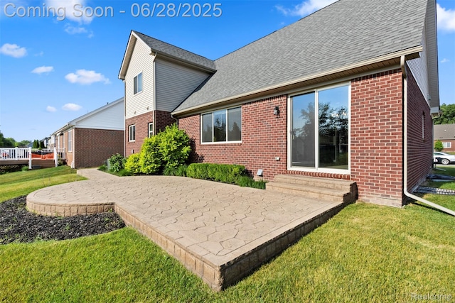30493 Bradmore Rd, Warren, MI 48092 - rear view of property featuring brick siding, entry steps, a yard, a patio, and a shingled roof